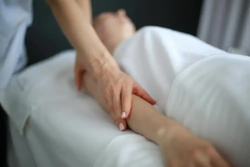 Therapist performing a gentle hand massage
