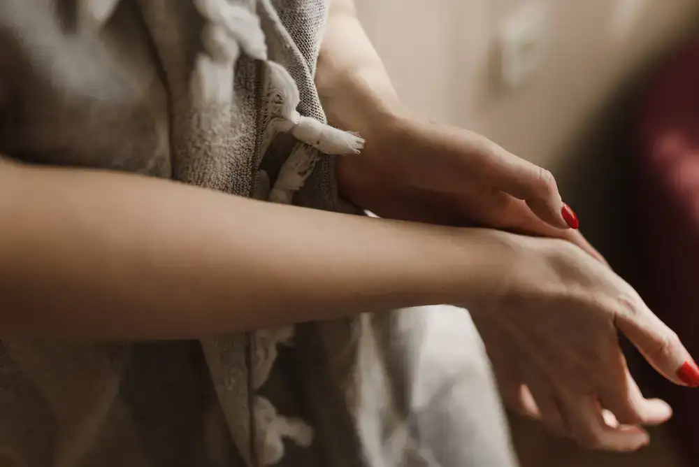 Freshly manicured hands resting on a soft towel